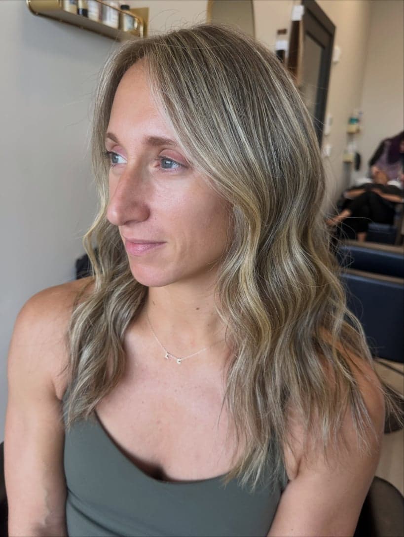 Soft, cool blonde babylights with brighter pieces framing the face, front view — hair by Alchemy Loft